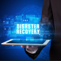 close up of man holding ipad with disaster recovery text