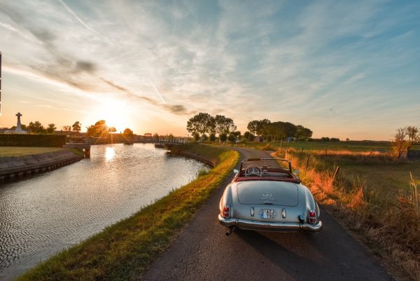 Collector vehicle driving onto the sunset